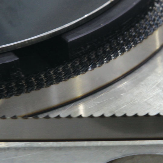 Close-up of hardened meat band-saw blade teeth